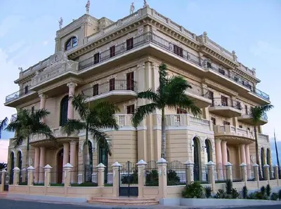 a large building with palm trees in front of it at Sea View Apartment in Boca Chica, 50 m², Air Conditioning in Boca Chica