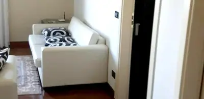 a living room with two white couches with pillows at Sea View Apartment in Boca Chica, 50 m², Air Conditioning in Boca Chica