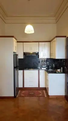 a kitchen with white cabinets and black appliances at Elegant apartment with Jacuzzi in Boca Chica - 200 m² in Boca Chica