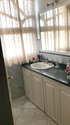 a bathroom with a sink and a mirror at Elegant apartment with Jacuzzi in Boca Chica - 200 m² in Boca Chica