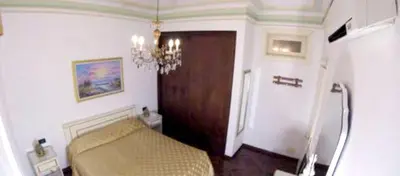 a bedroom with a couch and a wooden door at Modern apartment in Boca Chica – 75 m² with air conditioning in Boca Chica