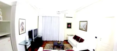 a living room with a white couch and a tv at Modern apartment in Boca Chica – 75 m² with air conditioning in Boca Chica