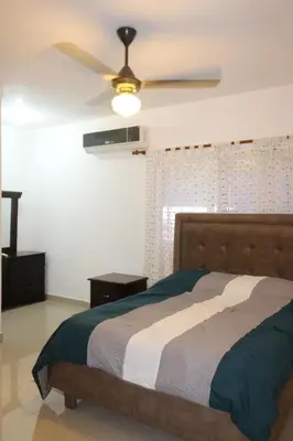 a bedroom with a bed and a ceiling fan at Apartamento Amueblado Amplio Tranquilo Privado Como tu lo Mereces in Santiago de los Caballeros