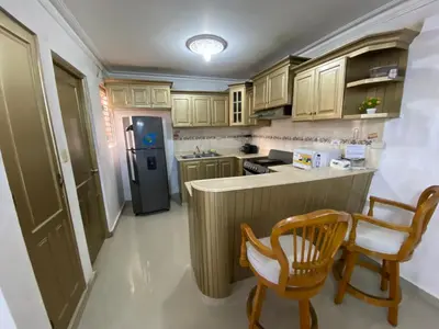 a kitchen with wooden cabinets and a refrigerator at Santo Domingo Paradise V - #211 in La Estrella