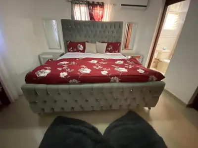 a bedroom with a large bed with a red comforter at Santo Domingo Paradise V - #211 in La Estrella