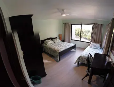 a bedroom with two beds and a window at Nanny Estates Cabarete kiters Condo C-6 in Cabarete