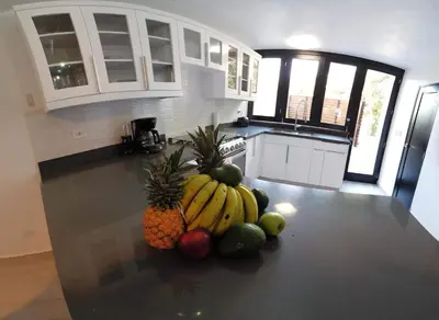a kitchen with a bunch of fruit on the floor at Nanny Estates Cabarete kiters Condo C-6 in Cabarete