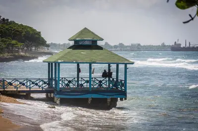 a blue lifeguard station on the beach in the water at Malecon Premium Rooms & Hotel in Santo Domingo