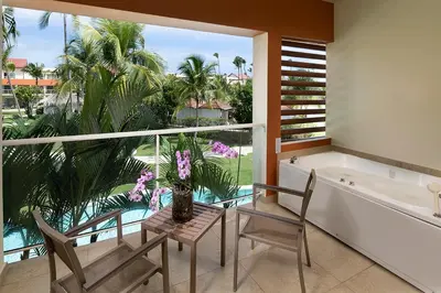 a bathroom with two chairs and a tub and a window at Breathless Punta Cana Resort & Spa - Adults Only - All Inclusive in Punta Cana
