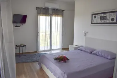 a bedroom with a large bed with flowers on it at Villa Laëti in Las Terrenas