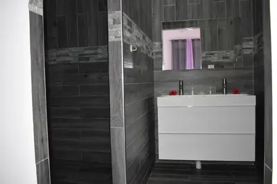 a bathroom with a white sink and a mirror at Villa Laëti in Las Terrenas
