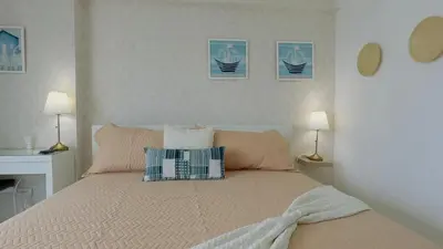 a bed with two pillows on it in a bedroom at Elegante Aqua Marine Apartamento Juan Dolio in Juan Dolio