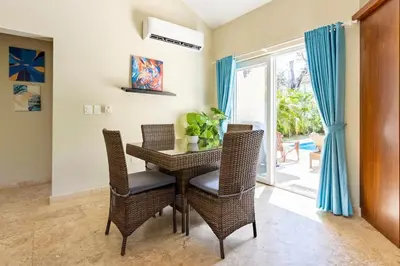 a dining room with a table and chairs and a patio at 2 Bed 2 Bath Villa with Jacuzzi, High Speed Wi-Fi in Sosúa