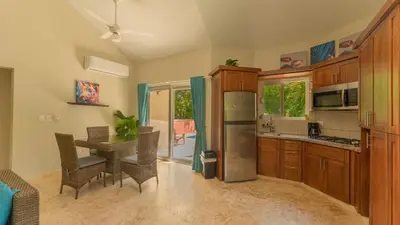 a kitchen with a table and chairs and a refrigerator at 2 Bed 2 Bath Villa with Jacuzzi, High Speed Wi-Fi in Sosúa