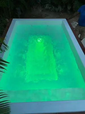 a swimming pool with green water in it at 2 Bed 2 Bath Villa with Jacuzzi, High Speed Wi-Fi in Sosúa