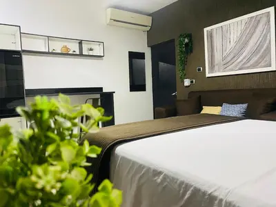 a hotel room with a bed and a window at Ocean Breeze Studios in Santo Domingo
