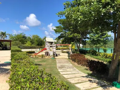 a playground in a park with a slide at Beautiful One Bedroom unit with pool and Beach club in a Golf Project in Punta Cana