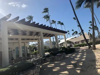 a pavilion at a resort with palm trees at Beautiful One Bedroom unit with pool and Beach club in a Golf Project in Punta Cana