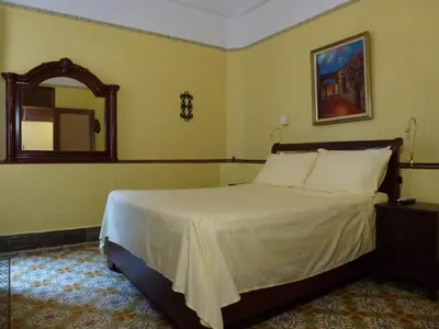 a bedroom with a large bed with a mirror at Residencial La Fonte in Santo Domingo