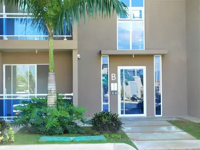 a building with a palm tree in front of it at Verano 2019 in Santiago de los Caballeros