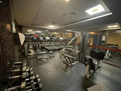 a gym with several rows of chairs and machines at Ramada by Wyndham Princess Santo Domingo in Santo Domingo