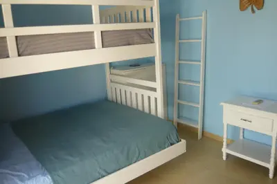 a bedroom with two bunk beds and a desk at The blue lagoon of the Caribbean Sea. Velero 205.Cadaques Caribe in La Fragata