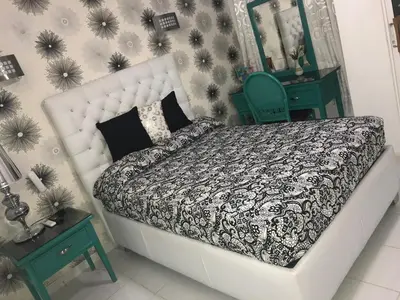 a bedroom with a bed and two tables and a mirror at Hotel Rey in Concepción de La Vega