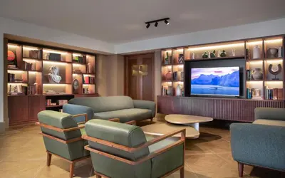 a living room with a tv and a couch and chairs at Camp David Ranch in Santiago de los Caballeros