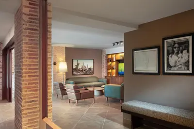 a living room with a couch and chairs at Camp David Ranch in Santiago de los Caballeros