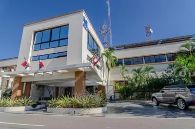 a car parked in front of a building at Matum Hotel & Casino in Santiago de los Caballeros