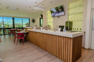 a restaurant with a bar with tables and chairs at Matum Hotel & Casino in Santiago de los Caballeros