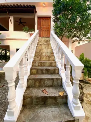a set of stairs leading up to a house at Hotel Alegria in Cabarete