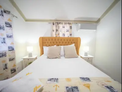 a bedroom with a large white bed with two tables at Charming 1b Apto Walk To The Beaches Main Street in Sosúa