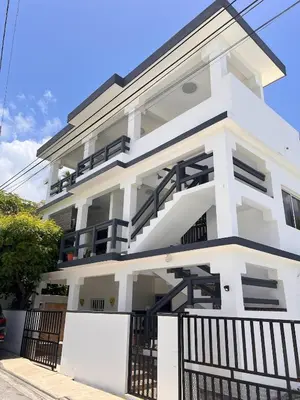 a white house with a black fence in front of it at Casa Lambí in Cabrera