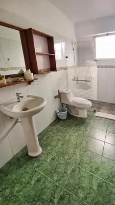 a bathroom with a sink and a toilet at Acuarium Suite Resort in Santo Domingo