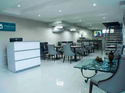 a dining room with tables and chairs in a restaurant at Malecon Cozy Private Room 6 in Santo Domingo