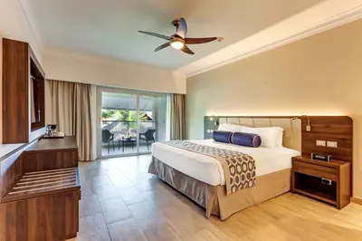 a bedroom with a bed and a ceiling fan at Royalton Splash Punta Cana, An Autograph Collection All-Inclusive Resort & Casino in Punta Cana