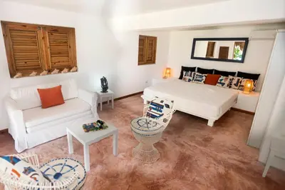 a living room with a bed and a couch at Studio Lotte - Ocean Front in Las Galeras