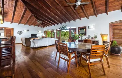 a living room with a wooden table and chairs at Penthouse Las Playas in Las Terrenas
