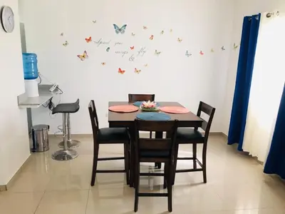 a dining room table with chairs and butterflies on the wall at 2bedroom mountain view villa #2 in Muñoz