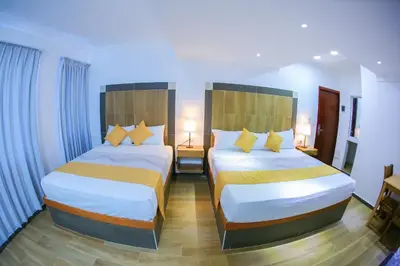 a hotel room with two beds in a room at Hotel Vicentina in Boca Chica