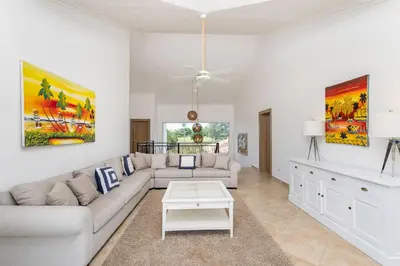 a living room with a couch and a table at Luxury & Modern Villa with Pool at Cocotal Golf & Country Club in Punta Cana