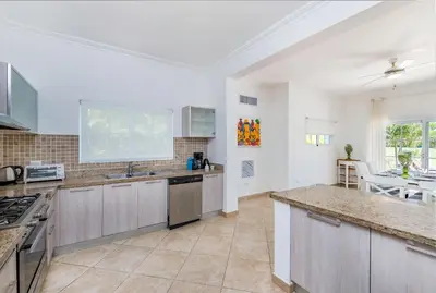 a large kitchen with a sink and a counter top at Luxury & Modern Villa with Pool at Cocotal Golf & Country Club in Punta Cana