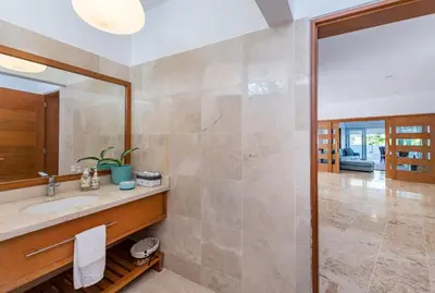 a bathroom with a sink and a mirror at Unique Private Villa with Pools and Golf Cart in La Romana