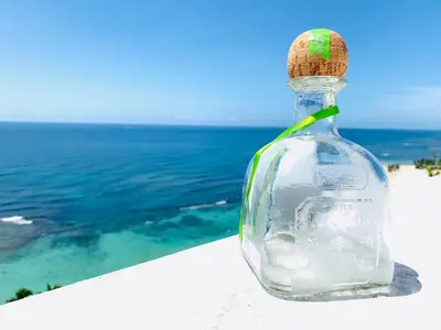 a bottle with a cork sitting on a ledge overlooking the ocean at Luxury penthouse portobello in Santo Domingo