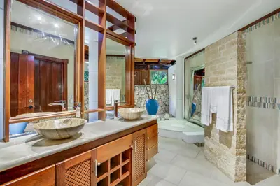 a bathroom with two sinks and a shower at Moroccan-Style Paradise with Pool & Maid at Casa de Campo in La Romana