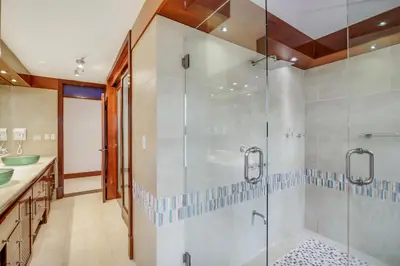 a bathroom with a shower and a glass shower stall at Moroccan-Style Paradise with Pool & Maid at Casa de Campo in La Romana