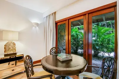 a dining room with a table and chairs and a window at Moroccan-Style Paradise with Pool & Maid at Casa de Campo in La Romana