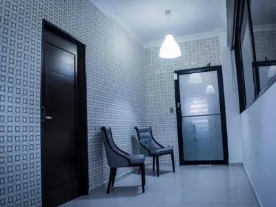 a waiting room with two chairs and a door at Malecon Premium Rooms in Santo Domingo