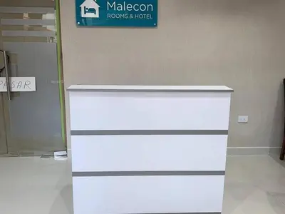 a white dresser in a room with a sign at Malecon Cozy - Premium Plus 5 in Santo Domingo